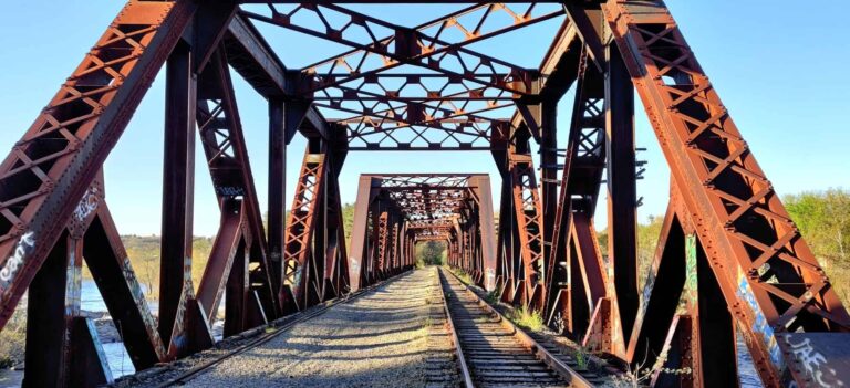 Photograph of rail bridge from one end, standing at one end and looking through to the other side.